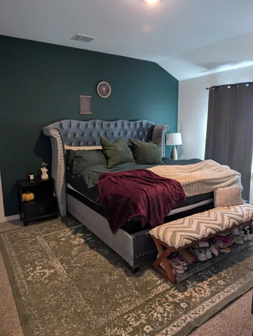 a bedroom with a bed and cabinet