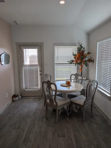 a view of a dining room with furniture and window