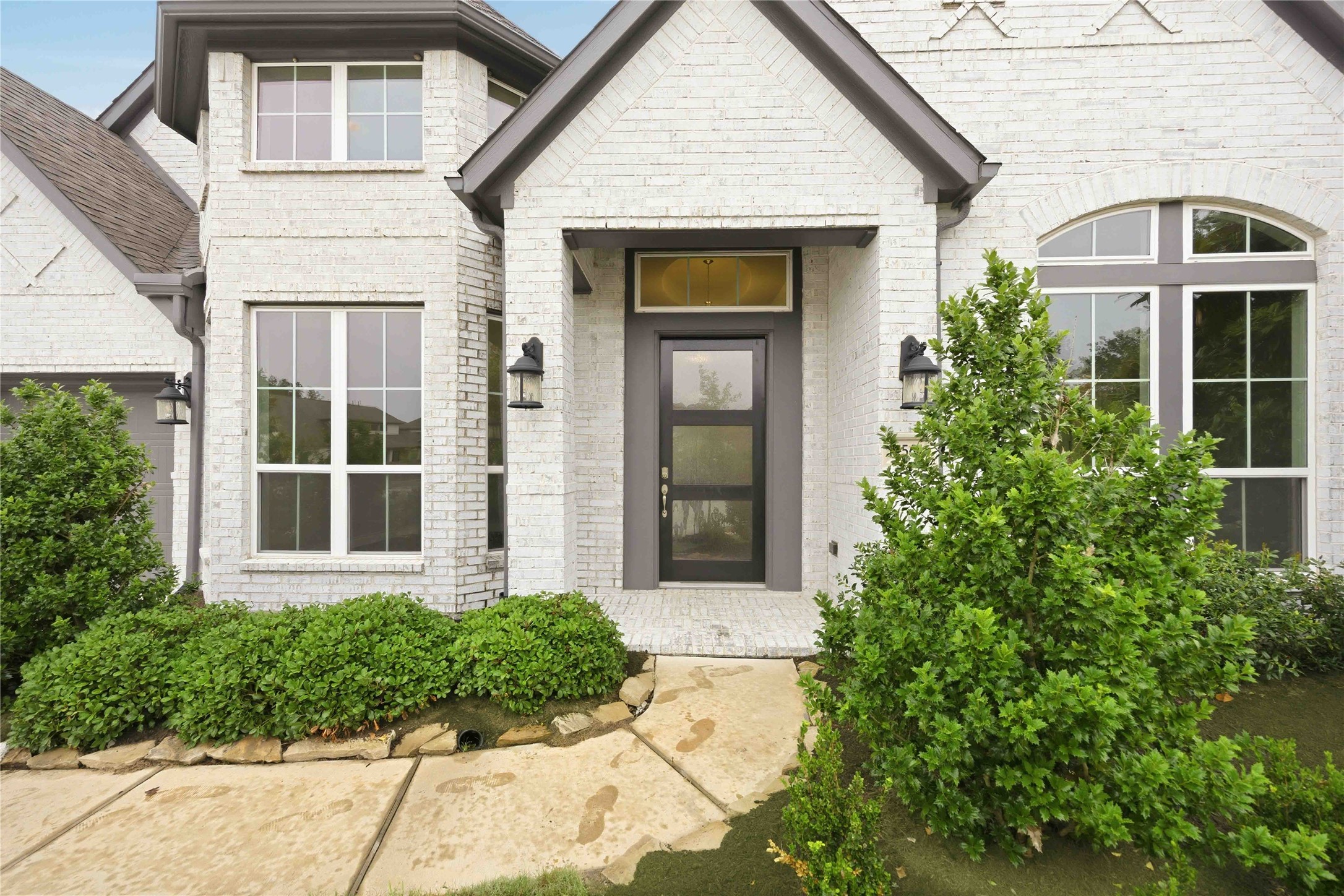 17564 Watercolor Way Conroe, TX 77302 - Photo 4 of 42 Lush landscaping adorn the elegant door and walkway