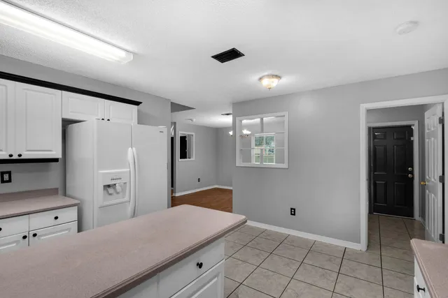 a kitchen with cabinets and refrigerator