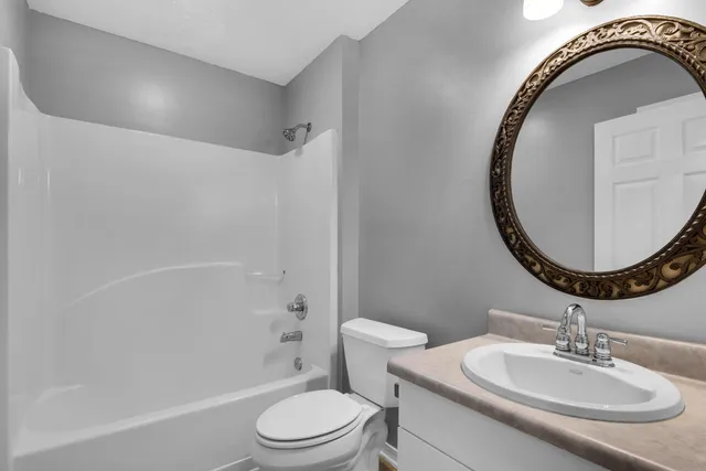 a bathroom with a sink a toilet and a mirror