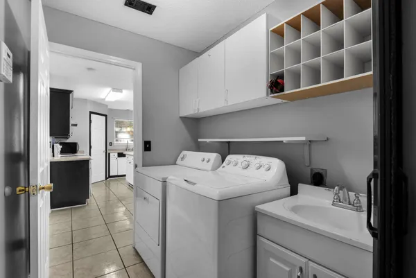 a view of washer and dryer with kitchen in the background
