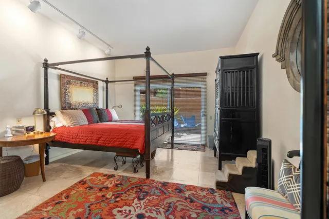 a bedroom with a bed and a table