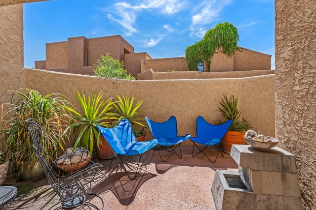 a blue and white vase with flowers sitting on a table