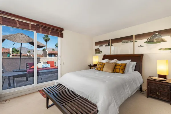 a bedroom with a bed and ceiling fan