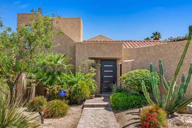 front view of a house with potted plants