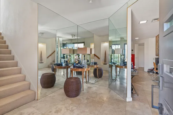 a view of a dining room with furniture and chandelier