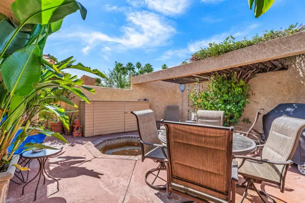 a view of a chairs and table in a patio