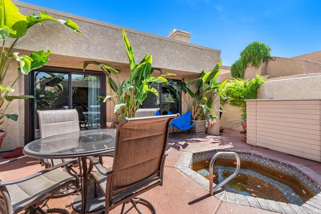 a view of backyard with outdoor seating and plants