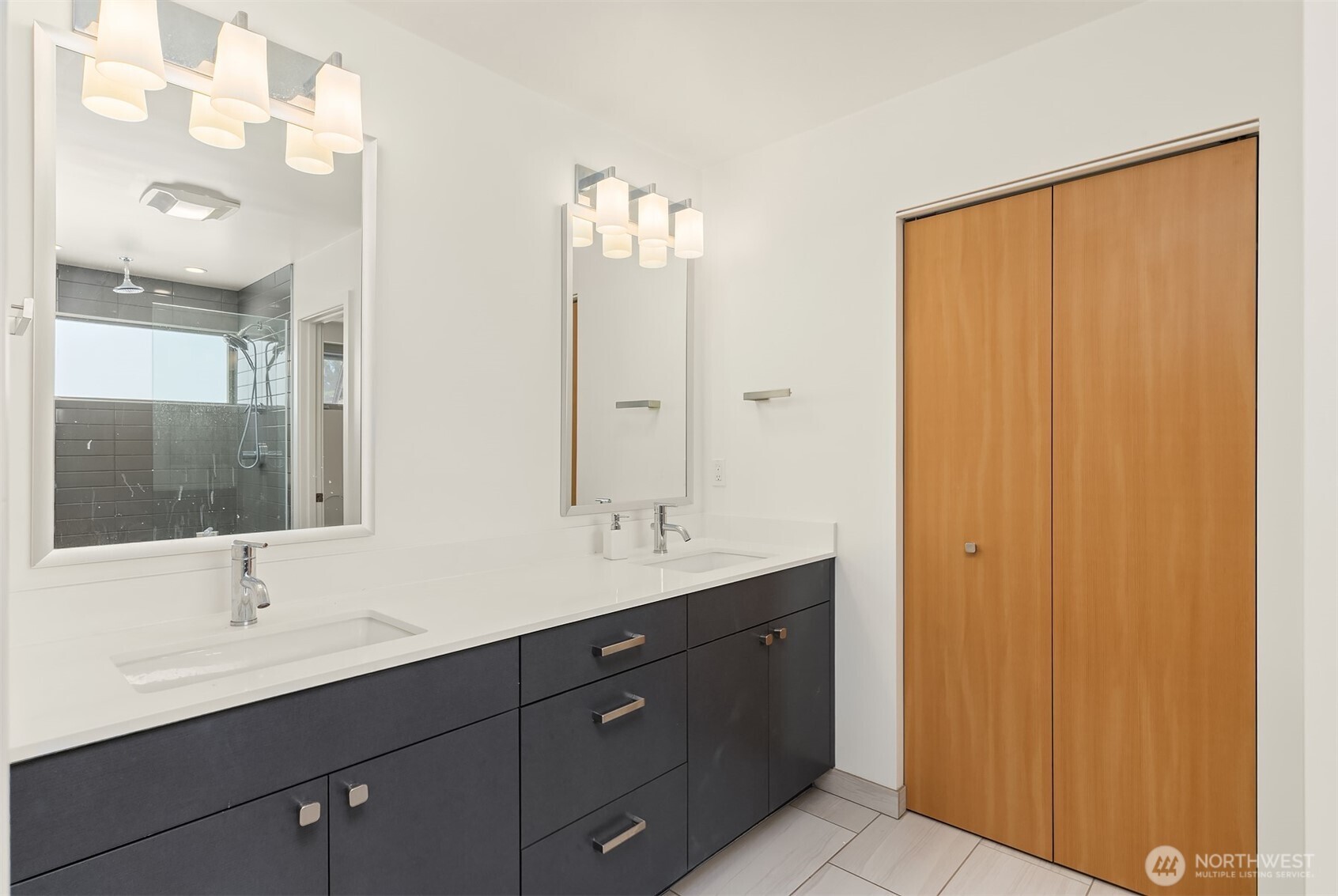 933 16th Avenue, Unit A Seattle, WA 98122 - Photo 12 of 19 a bathroom with a double vanity sink a and mirror