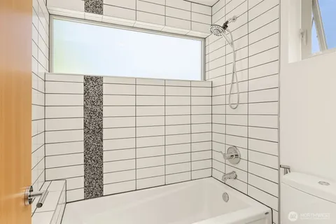 a bathroom with a bathtub and shower