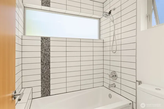 a bathroom with a bathtub and shower