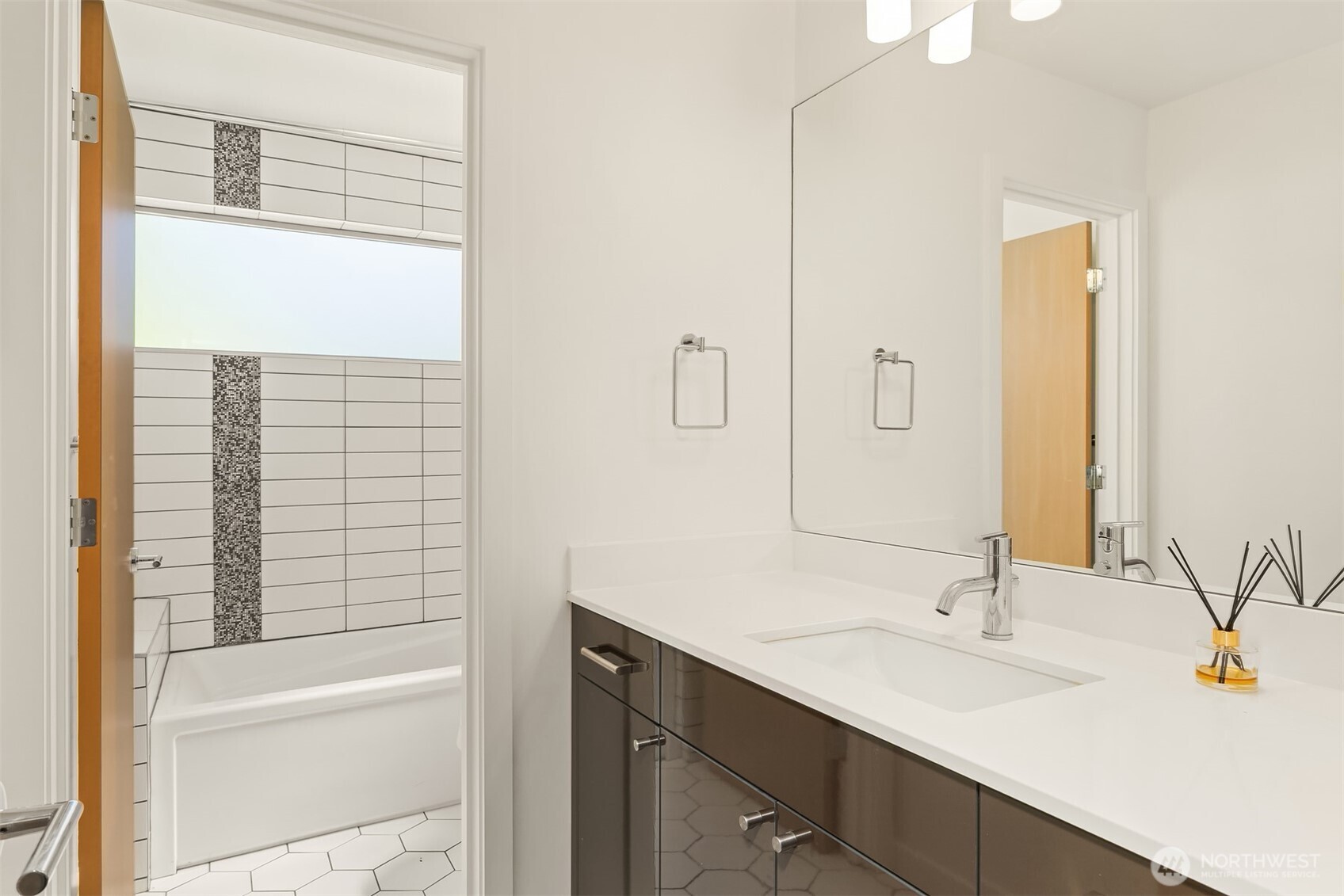 933 16th Avenue, Unit A Seattle, WA 98122 - Photo 15 of 19 a bathroom with a sink and a mirror