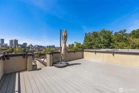 a view of a terrace with wooden floor and city view