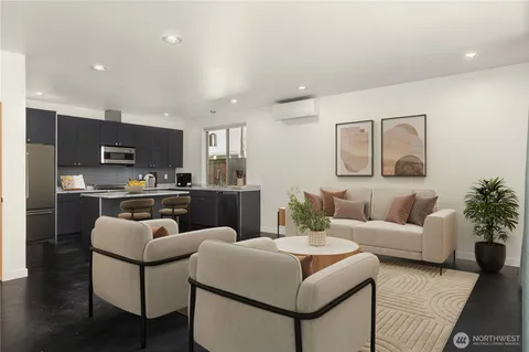 a living room with furniture and kitchen view