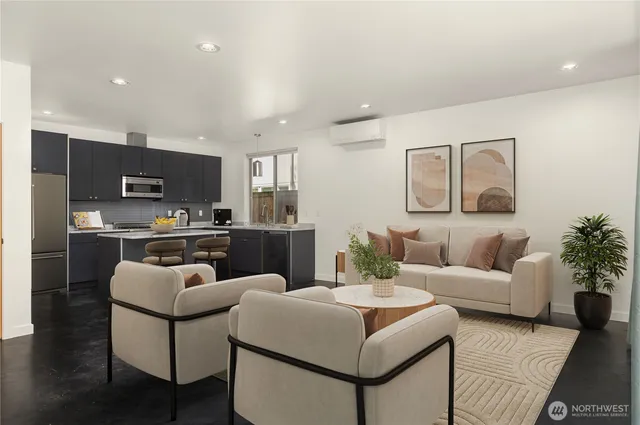 a living room with furniture and kitchen view