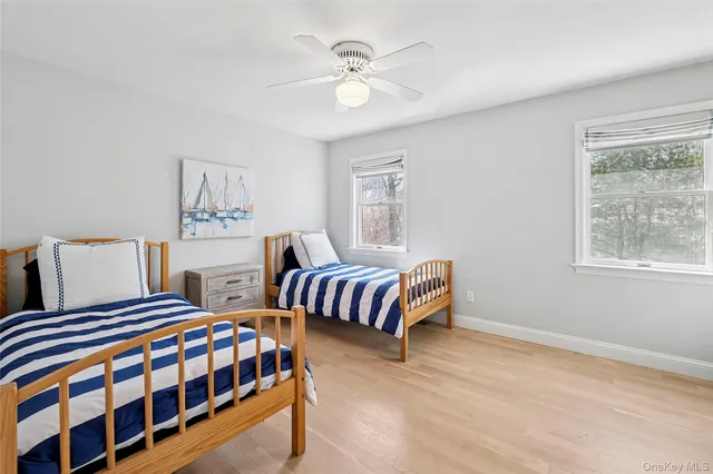 a bedroom with two beds and a window