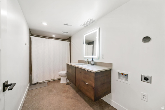3667 Little Cottonwood Road, Unit 1 Sandy, UT 84092 - Photo 28 of 49 Modern bathroom featuring a floating wood-finish vanity with an integrated sink and light-framed mirror