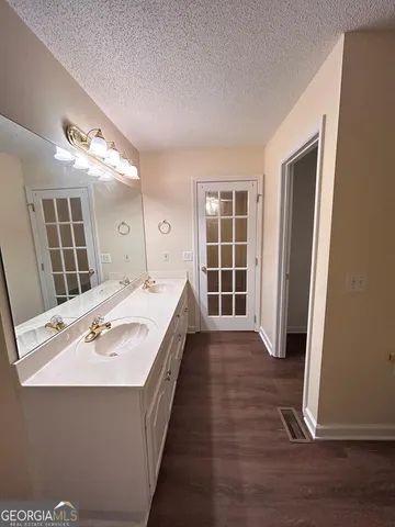 a spacious bathroom with a tub shower and a sink