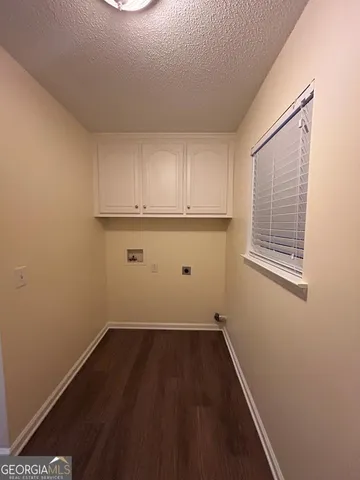 a view of a room with wooden floor and cabinets