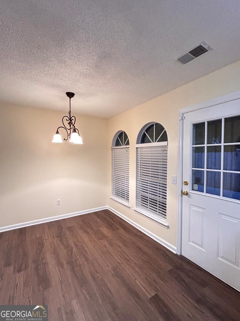 1696 Red Oak Drive, Unit 184 Dalton, GA 30721 - Photo 10 of 21 a view of an empty room with a window and wooden floor