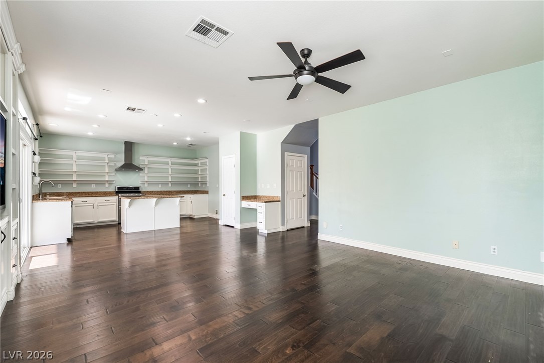 261 Timber Hollow Street Henderson, NV 89012 - Photo 11 of 51 Rich hardwood floors unite an open-concept living space and a well-appointed kitchen.