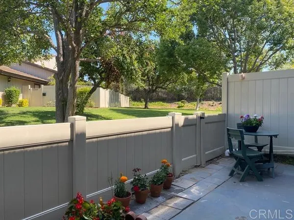 a backyard of a house with table and chairs