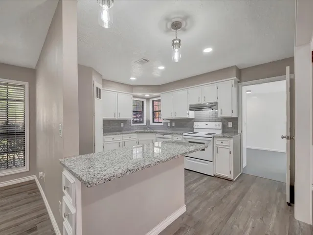 a kitchen with stainless steel appliances granite countertop wooden cabinets and a granite counter tops