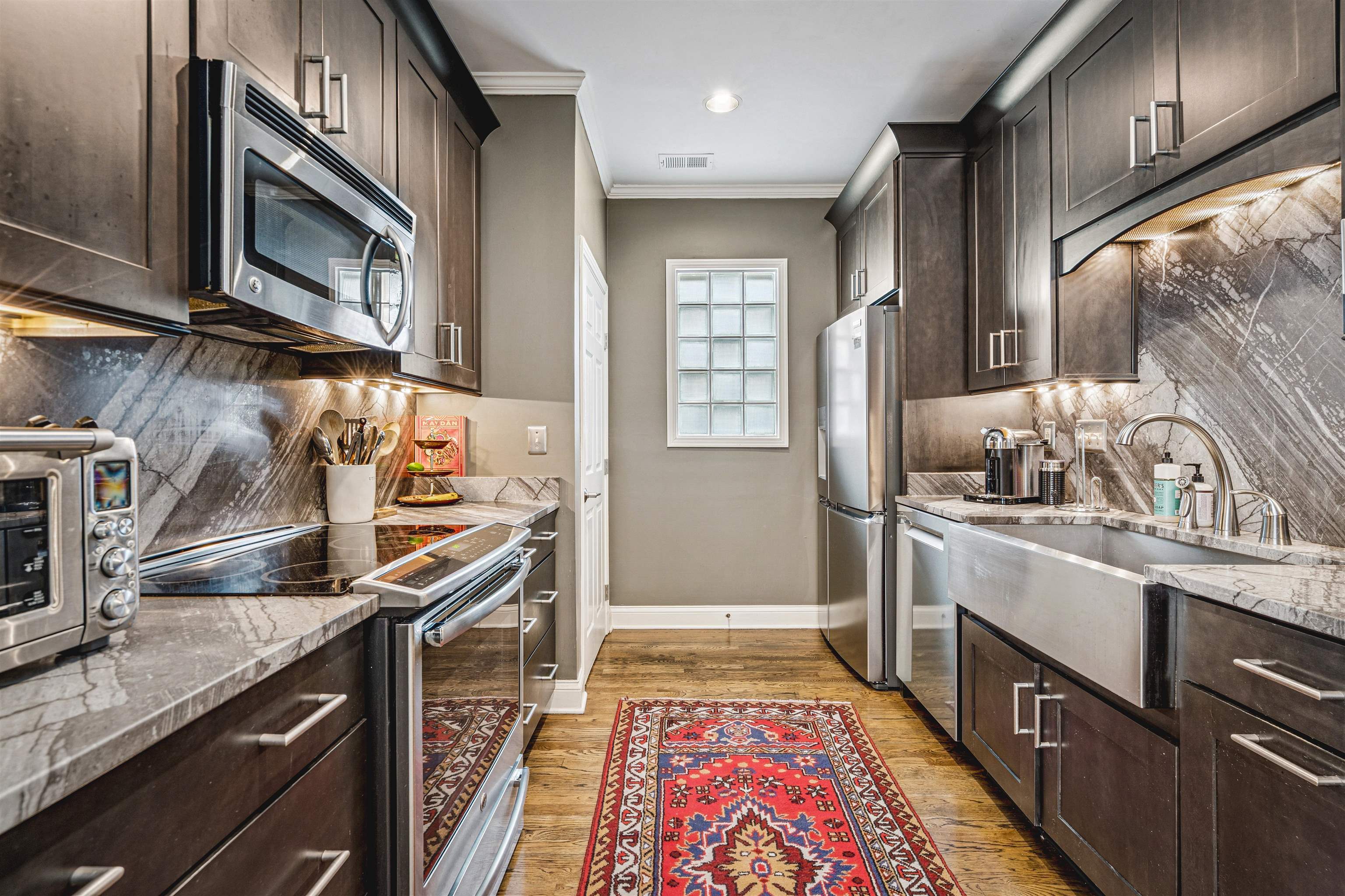942 Harbor Bend Road Memphis, TN 38103 - Photo 11 of 25 a kitchen with stainless steel appliances granite countertop a sink stove and cabinets