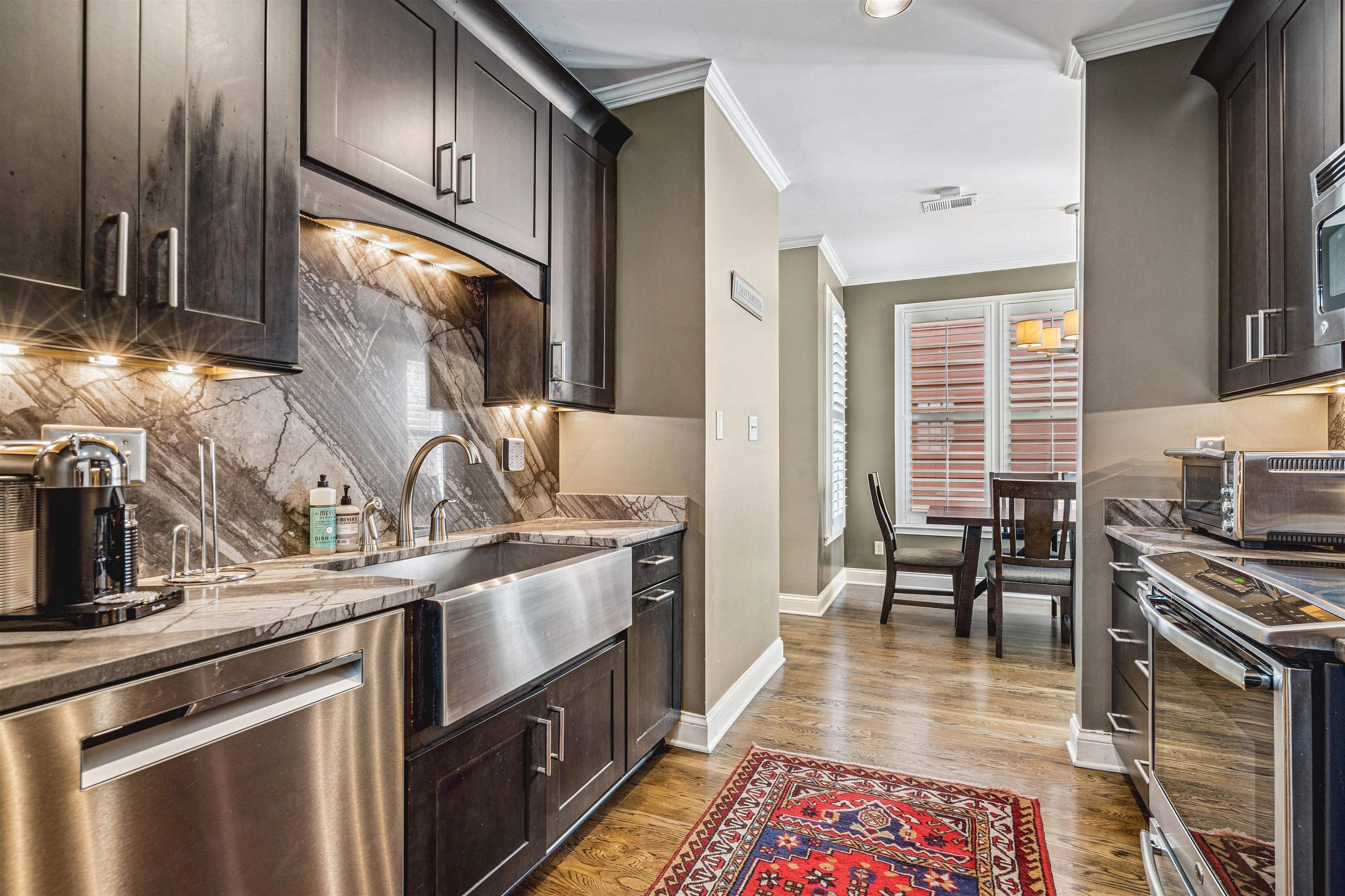 942 Harbor Bend Road Memphis, TN 38103 - Photo 12 of 25 a kitchen with stainless steel appliances granite countertop a sink stove and refrigerator