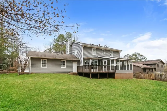 a view of a house with a garden and pathway