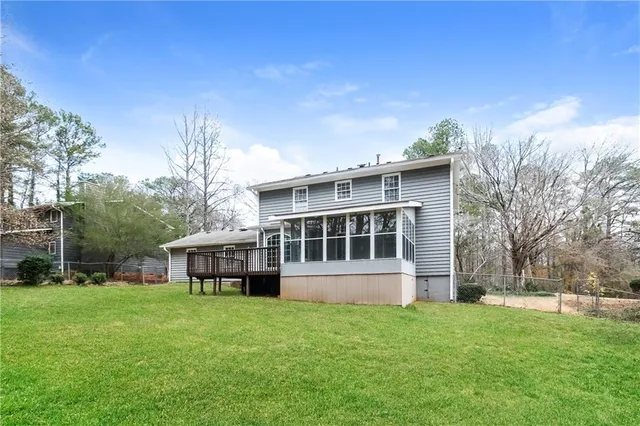 a view of a house with yard and sitting area