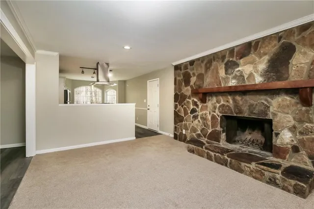 a view of empty room with a fireplace