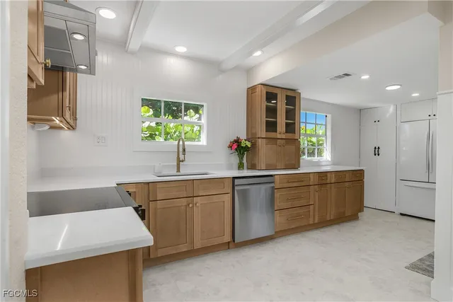 a kitchen with sink and window