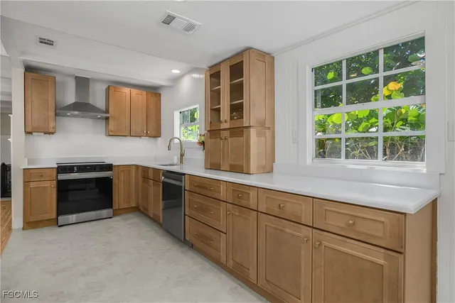 a kitchen with stainless steel appliances granite countertop a stove and a sink