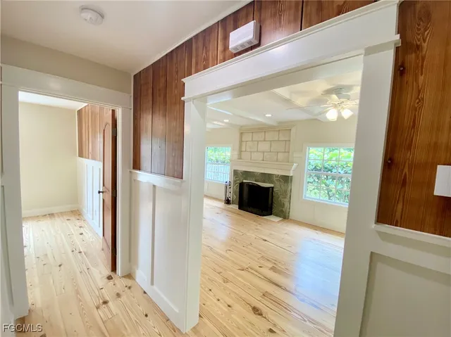 view of an entryway with wooden floor and a fireplace