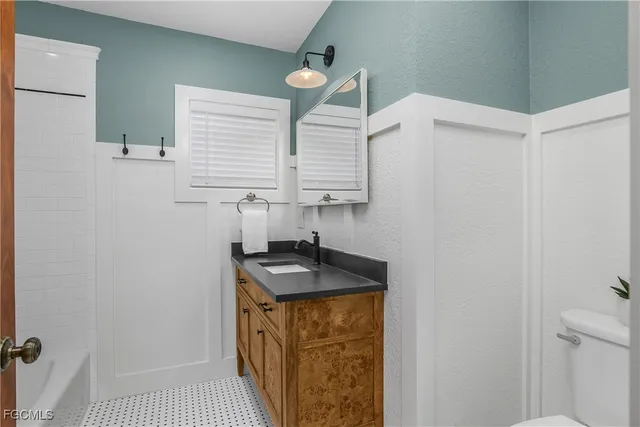 a kitchen with a sink a stove and a window