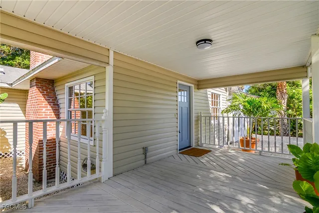 a view of a porch with wooden floor and iron stairs