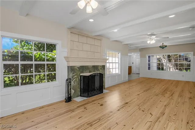 a view of a livingroom with a fireplace and window