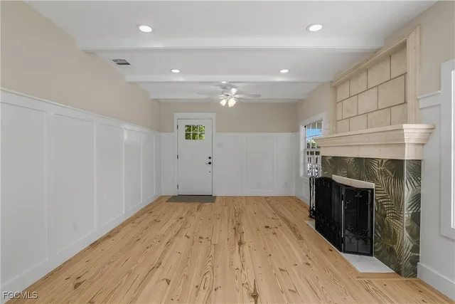 wooden floor in an empty room with a fireplace