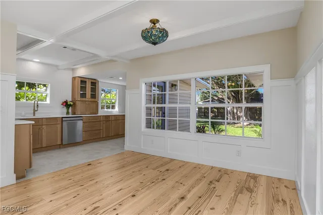 a view of a kitchen with wooden floor and a window