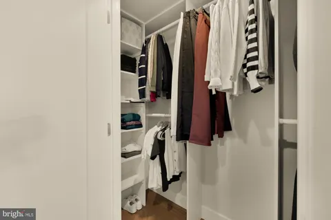 a bedroom with a bed and dresser with mirror