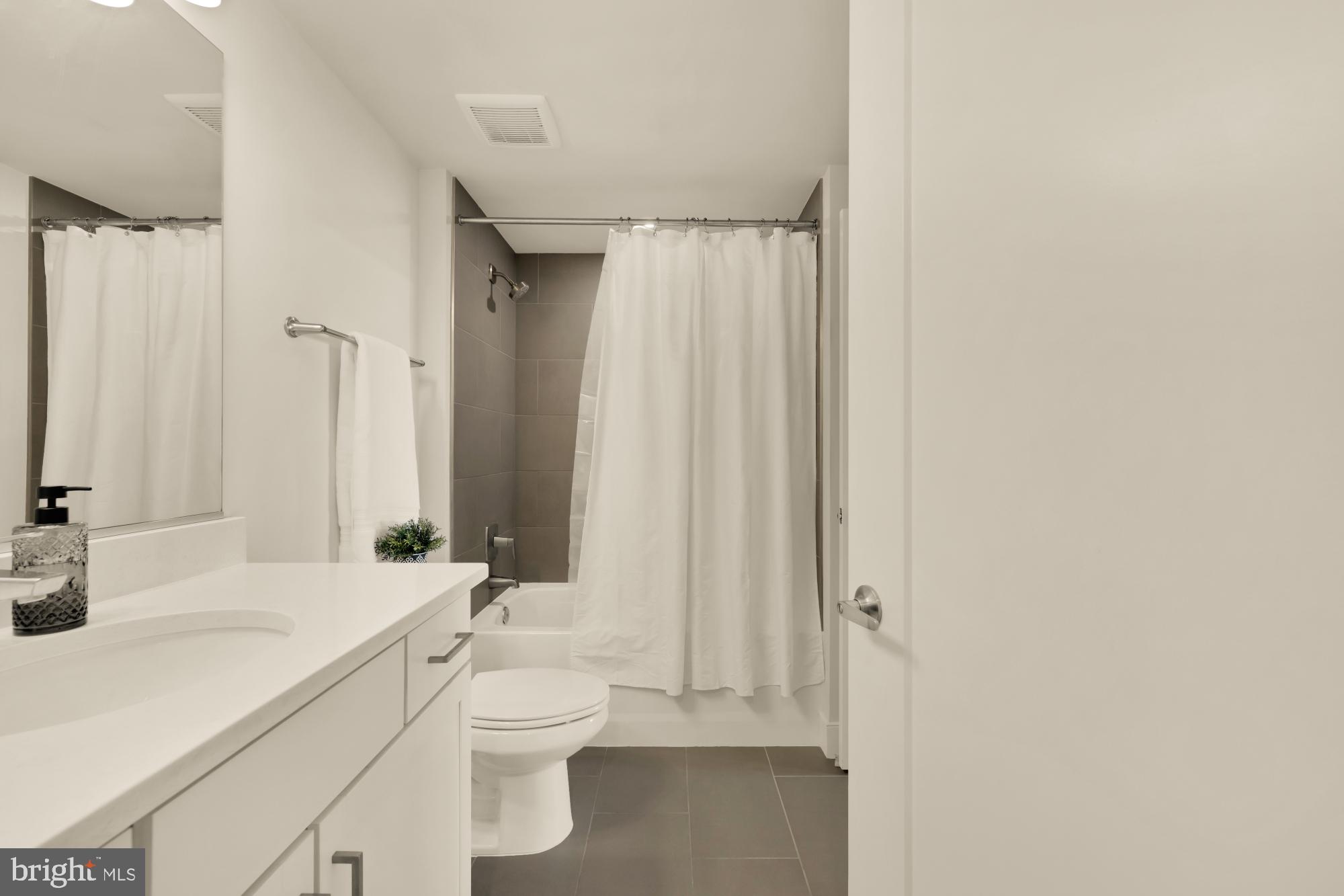 50 Florida Avenue Northeast, Unit 412 Washington, DC 20002 - Photo 11 of 29 a bathroom with a sink a toilet and shower