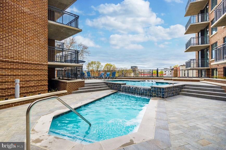 50 Florida Avenue Northeast, Unit 412 Washington, DC 20002 - Photo 16 of 29 a view of a swimming pool with a lounge chairs