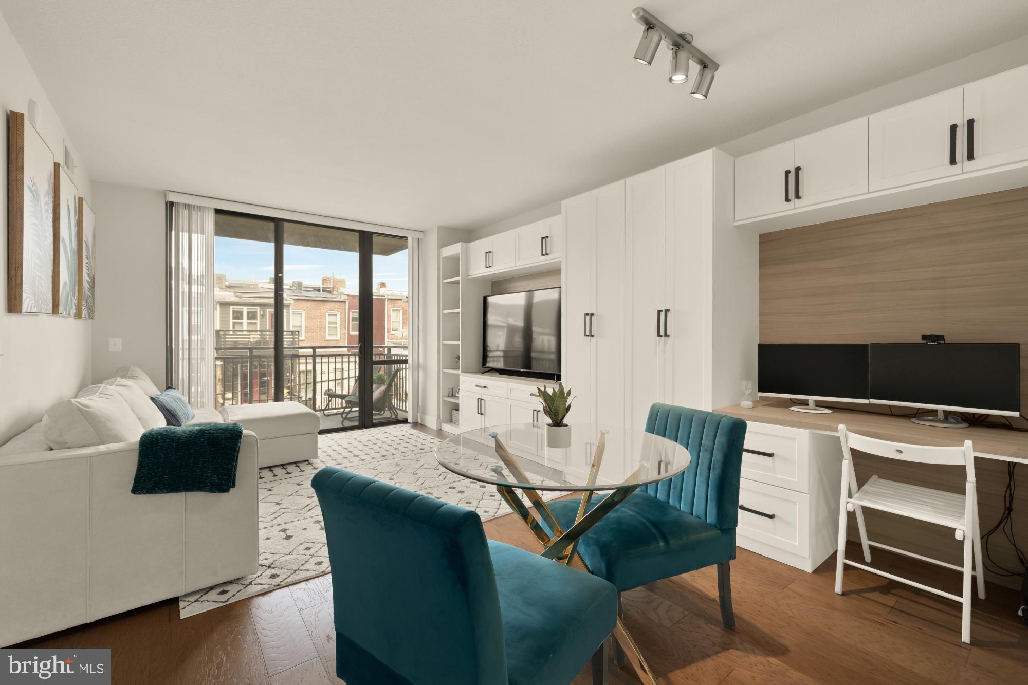 a living room with furniture a flat screen tv and a large window