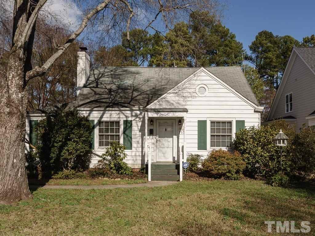 713 Kimbrough Street Raleigh, NC 27608 - Photo 1 of 25 a view of a white house next to a yard with big trees