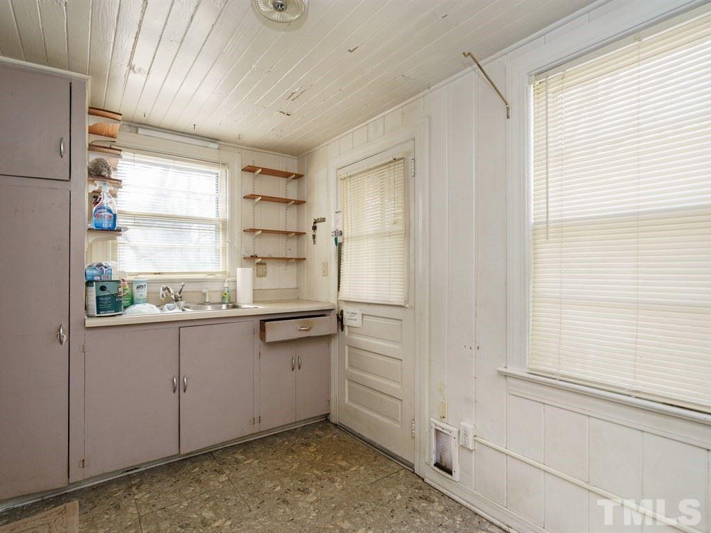 713 Kimbrough Street Raleigh, NC 27608 - Photo 12 of 25 a kitchen with granite countertop white cabinets and white appliances