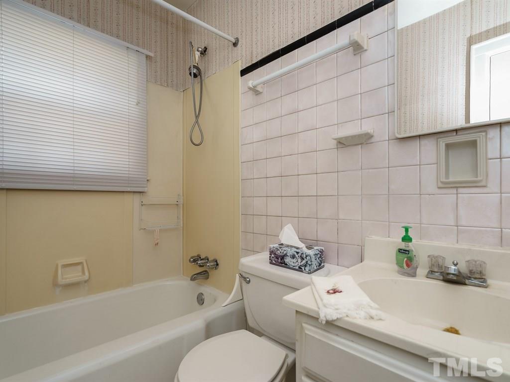 713 Kimbrough Street Raleigh, NC 27608 - Photo 17 of 25 a bathroom with a sink a toilet and a bathtub