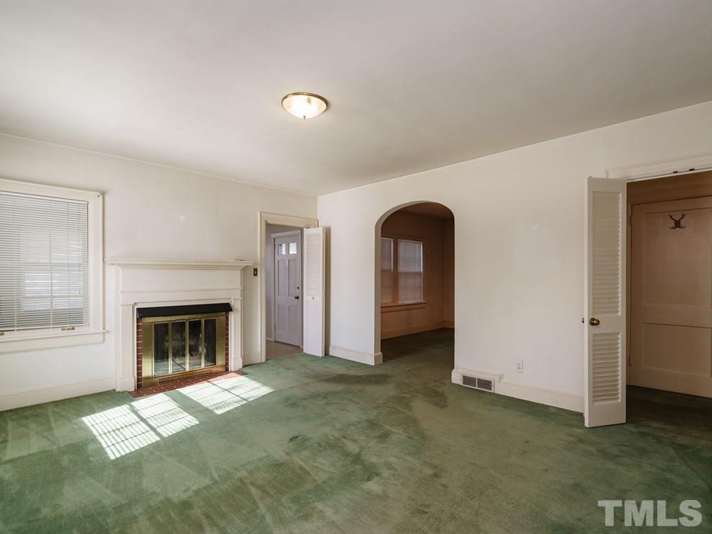 713 Kimbrough Street Raleigh, NC 27608 - Photo 3 of 25 a view of empty room with fireplace