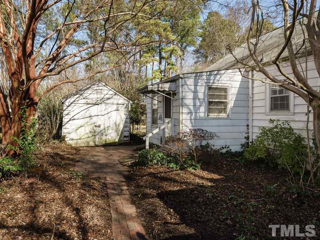 713 Kimbrough Street Raleigh, NC 27608 - Photo 22 of 25 a view of a house with a yard